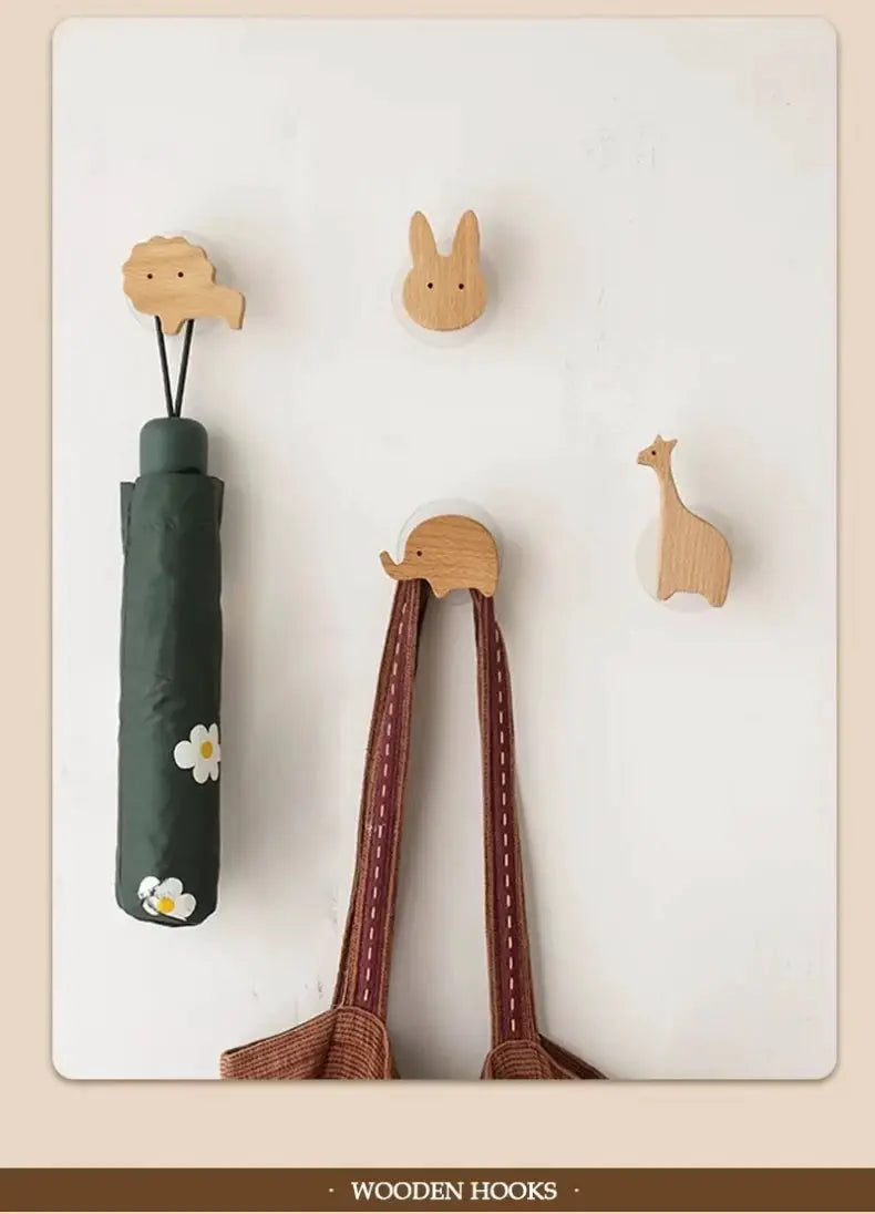Wooden animal wall hooks by Simples Market; 4 natural wood hangers shaped as cloud, bunny, elephant, and giraffe