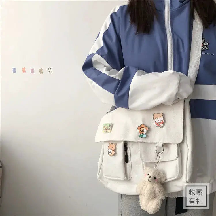 Simples Market women's white canvas messenger bag with cartoon patches and plush teddy keychain
