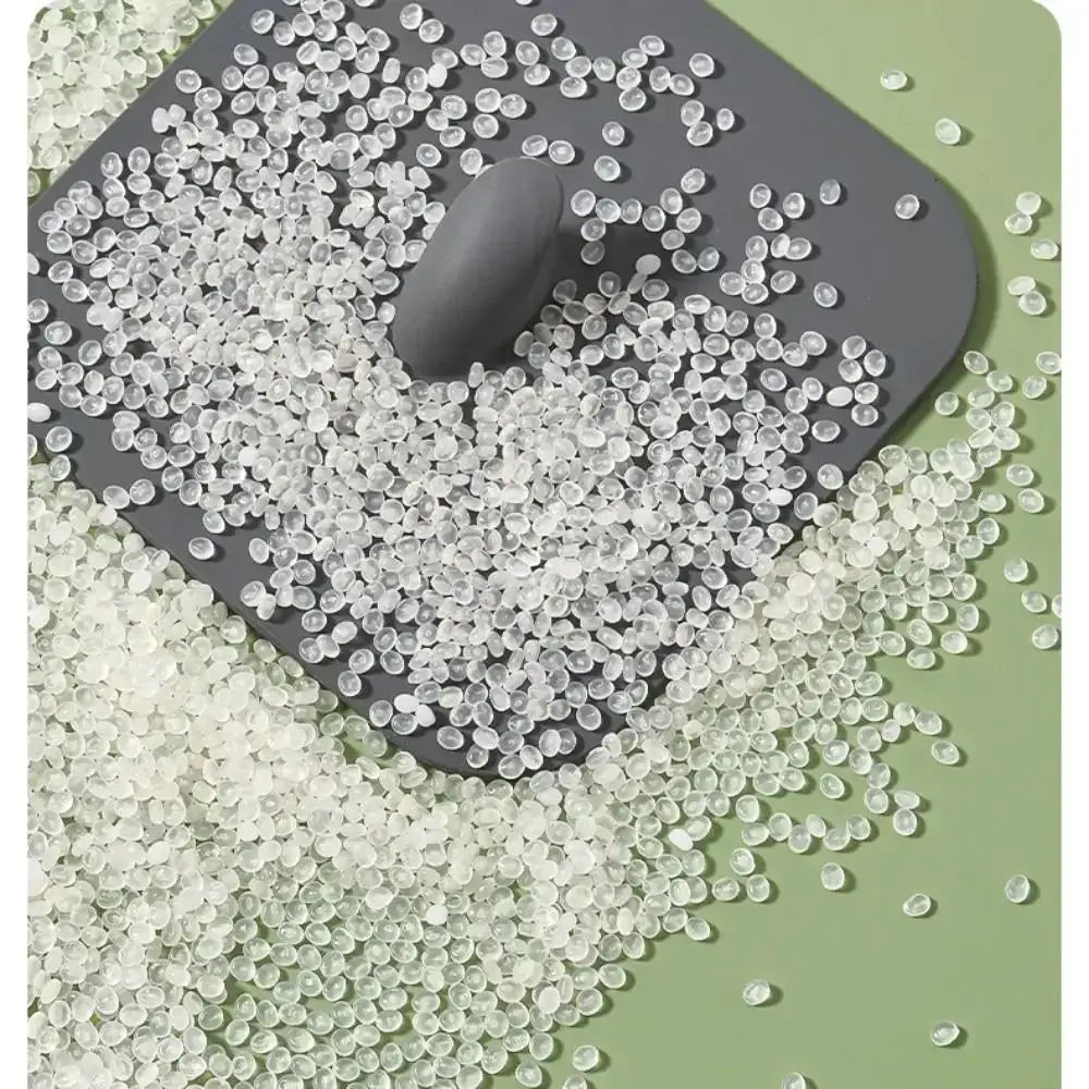 Silicone bathroom drain deodorant pad with white beads around a gray drain cover