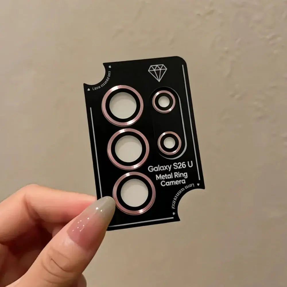 Camera lens ring metal set in rose gold for Galaxy S26 Ultra, shown on black display card