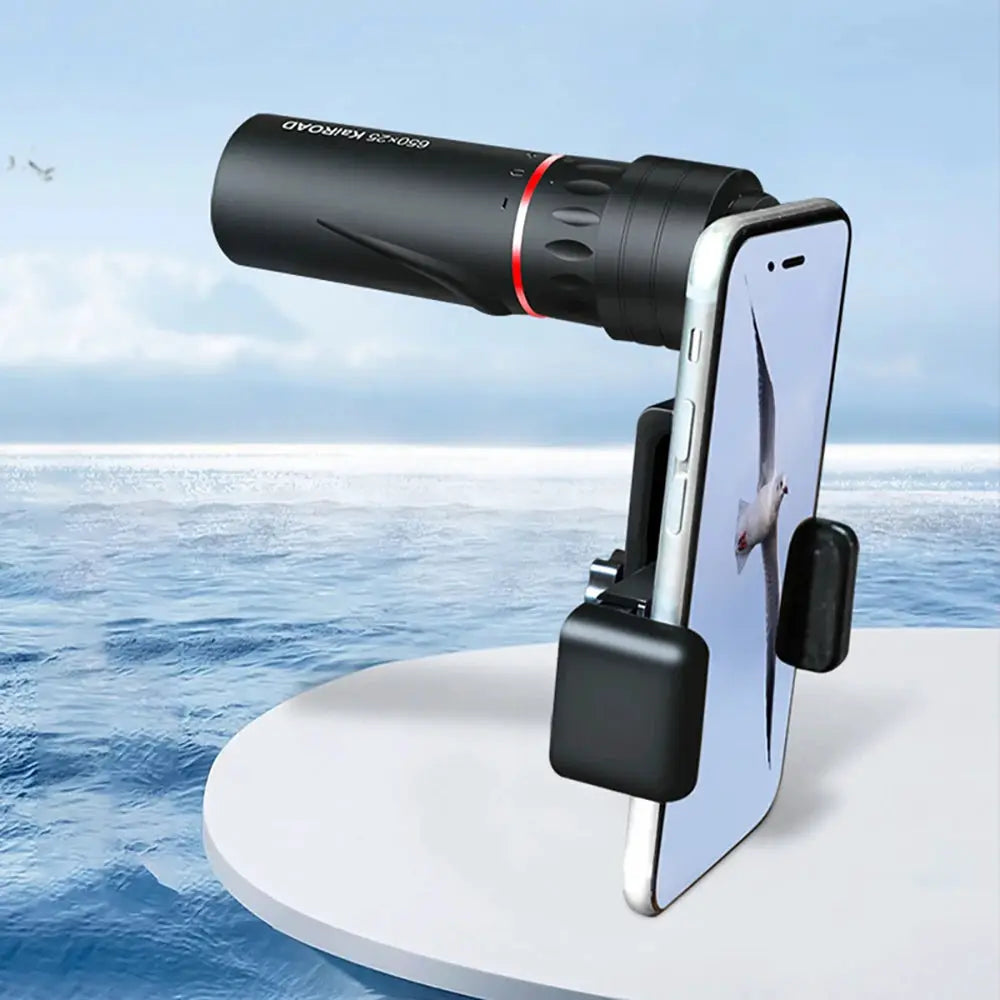 Monocular telescope with phone adapter attached to a smartphone; black body with red ring for stargazing.