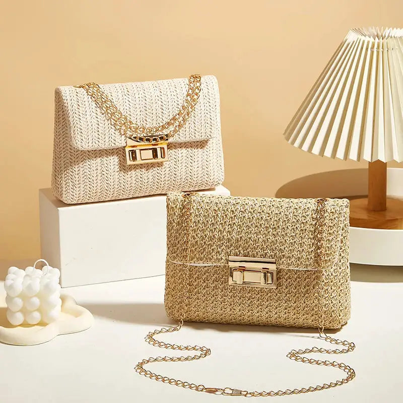 Crossbody bags for women; two woven chain-strap purses in cream and natural straw with gold hardware.