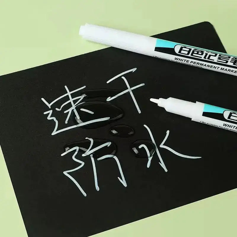 Simples Market white marker pens; waterproof oily permanent markers with 0.7/1.0/2.5mm tips, two pens shown.