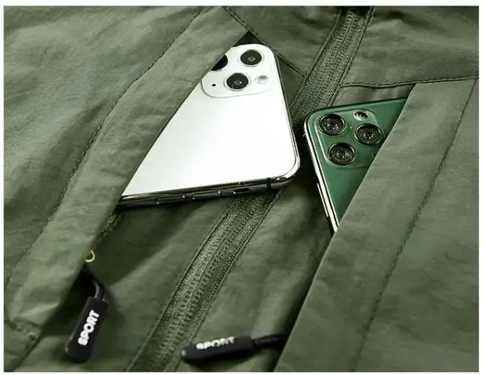 Men's olive green cargo vest with breathable mesh and zip pockets; two smartphones visible in front pockets.