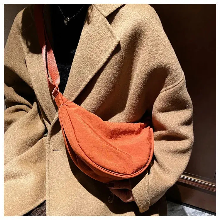 Casual nylon hobo crossbody bag by Simples Market in orange; large-capacity women's shoulder bag.