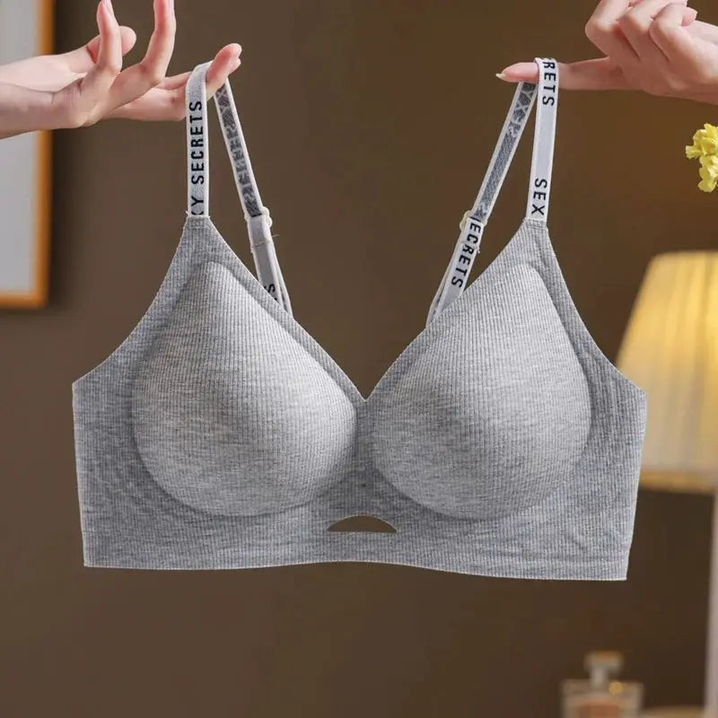 Grey seamless wireless push-up sports bra by Simples Market with branded straps