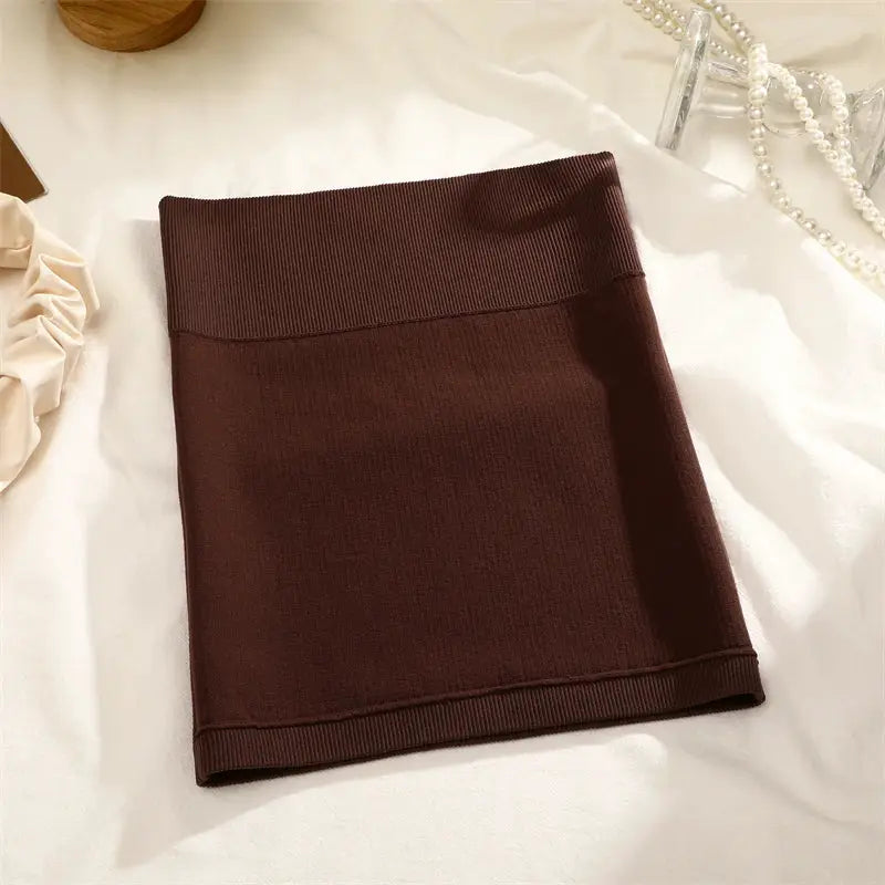 Women's brown ribbed high-waist mini skirt; soft stretchy knit, versatile office/pencil style.