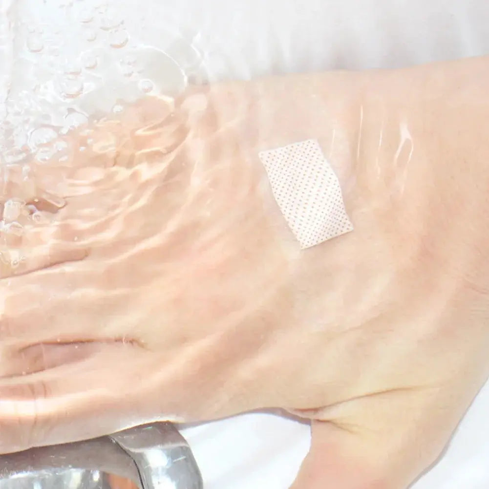 Waterproof transparent adhesive wound plaster on foot with dotted patch