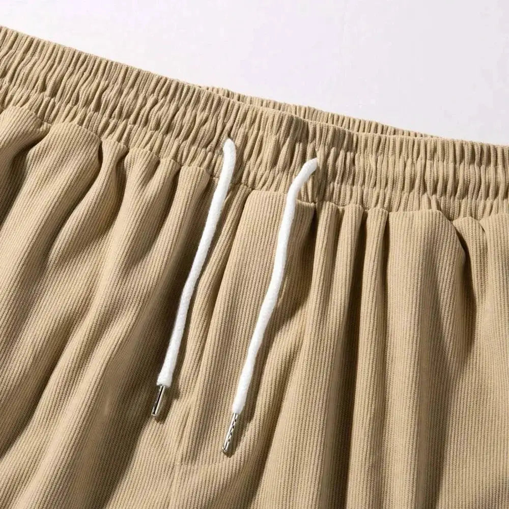 Men's beige corduroy shorts with elastic waistband and white drawstrings