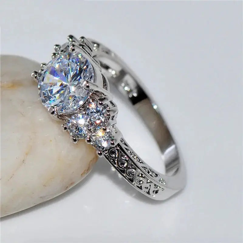 Silver engagement ring with white zircon stones and ornate filigree band by Simples Market