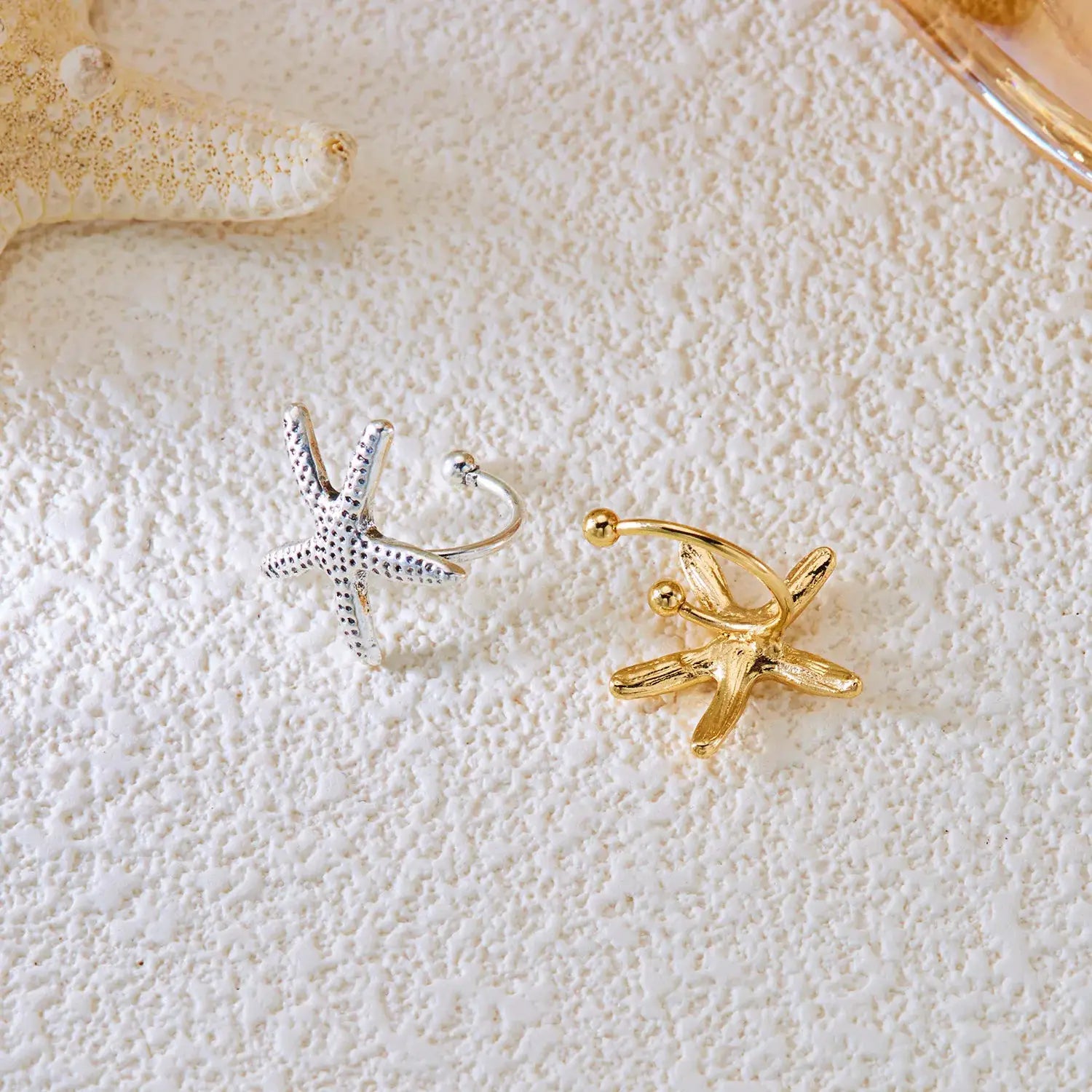 Trendy starfish ear clips by Simples Market in silver and gold tones (set of 2)