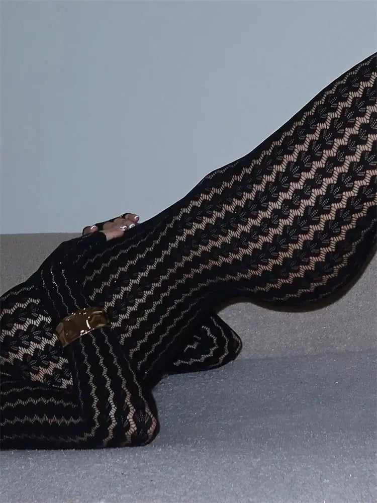 Tossy see-through black lace jumpsuit with wrap hollow-out pattern and gold belt buckle.