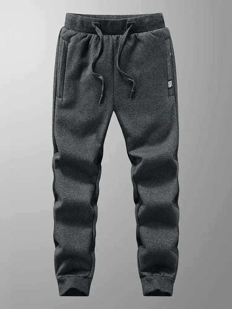 Men's charcoal fleece joggers with drawstring waist, zip pockets, cuffed ankles