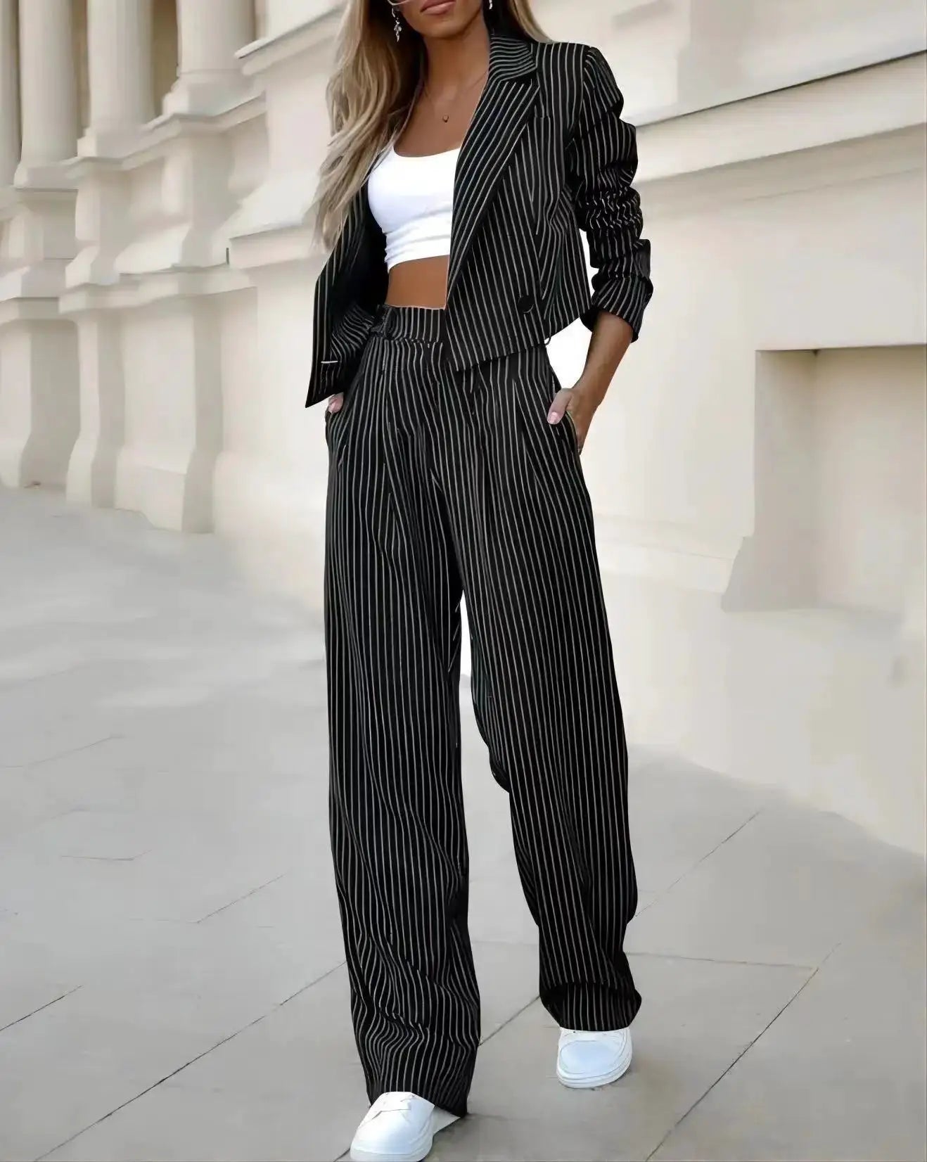 Women's black pinstripe blazer and wide-leg pants suit with white crop top by Simples Market