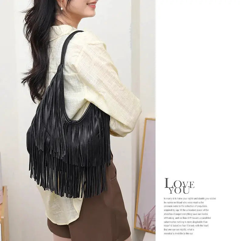 Long tassel shoulder bag by Simples Market in black soft PU leather with fringe tassels