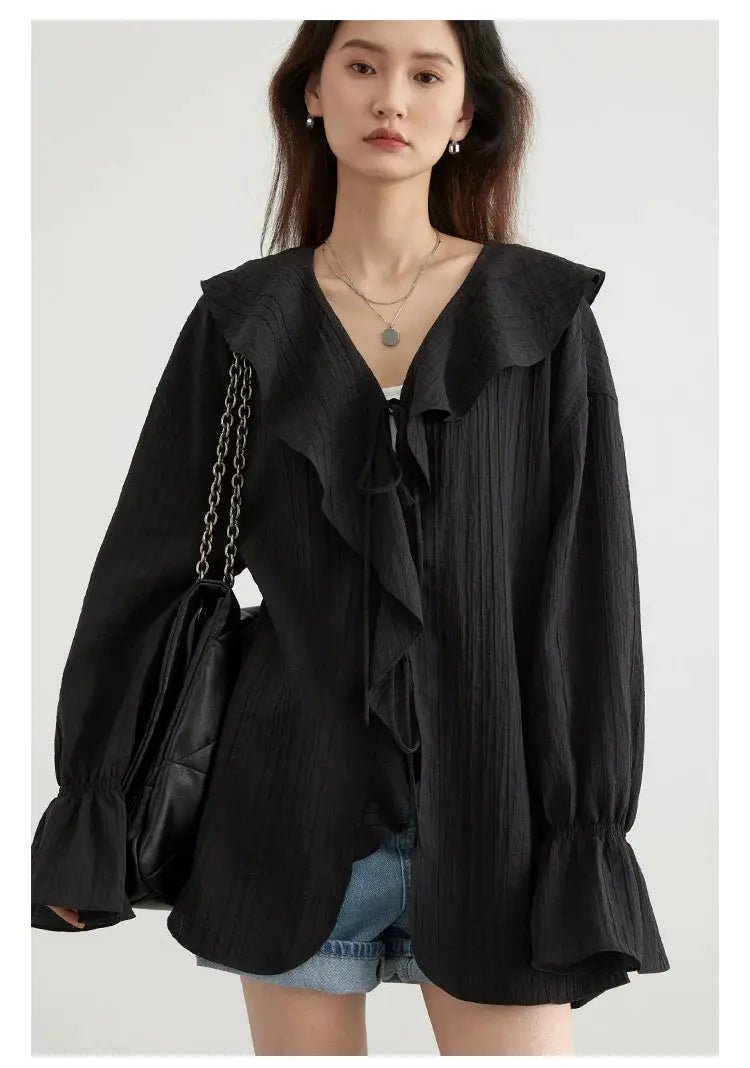 CHIC VEN women's black loose shirt with ruffled edges, V-neck lace-up detail, and puff sleeves.