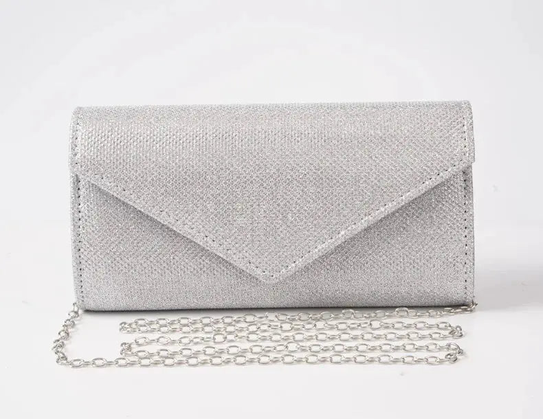 Envelope glitter evening bag in silver with a chain shoulder strap by Simples Market