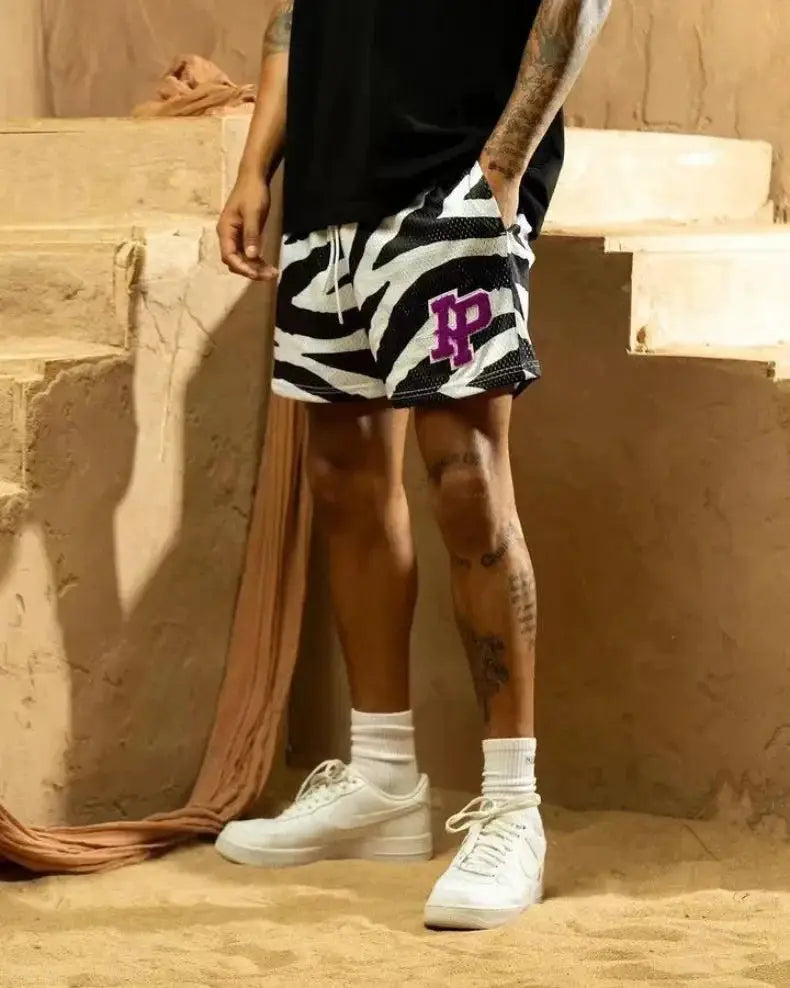Men's mesh quick-dry athletic shorts in black and white zebra print with a purple logo patch