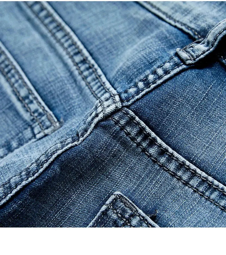 Men's blue denim shorts close-up showing stitching and seam details