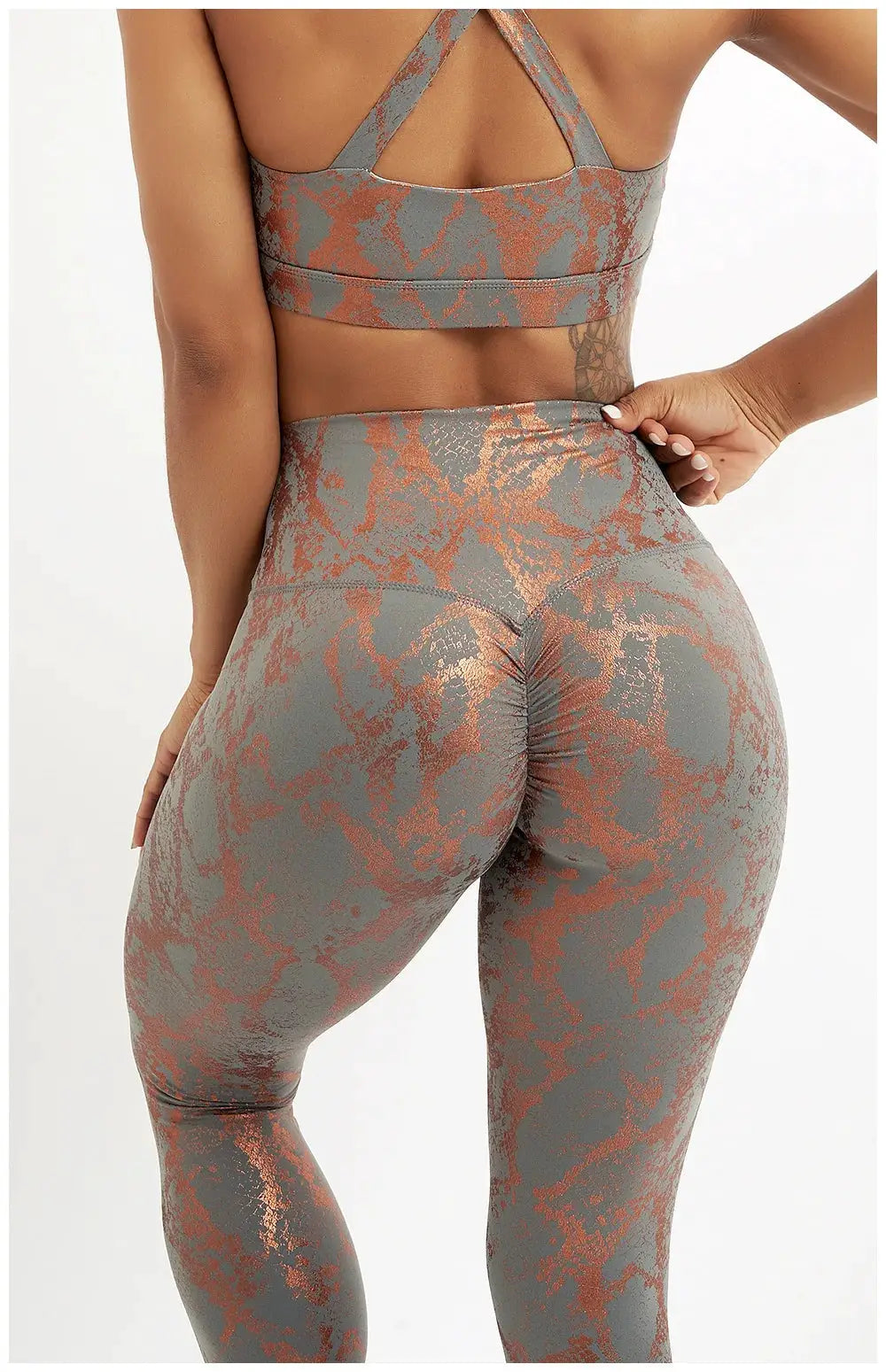 Snake-print yoga pants in gray with copper metallic pattern, high-waisted stretch leggings for women