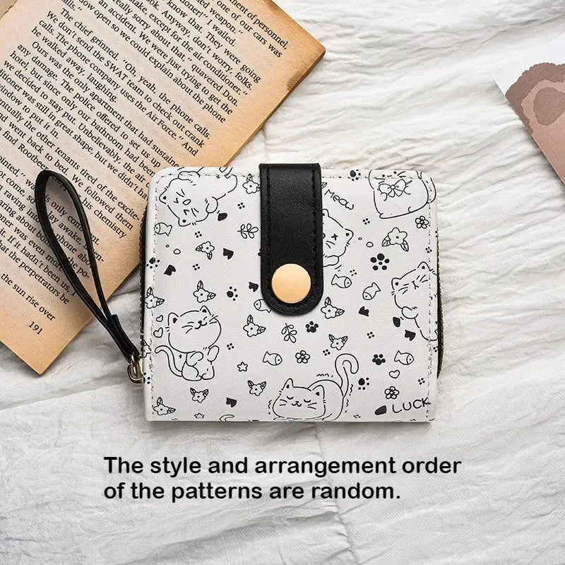 Japanese cute cat girls wallet with white background and black cat print, black strap, gold snap closure