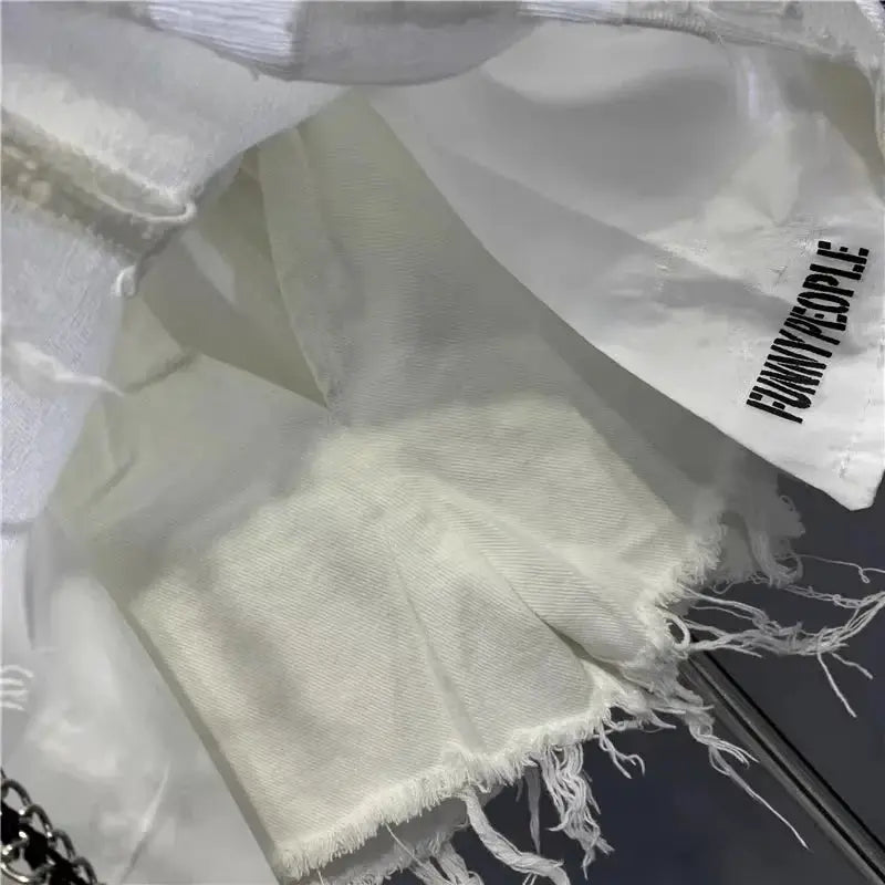 White raw denim skirt with frayed hem and distressed edge texture