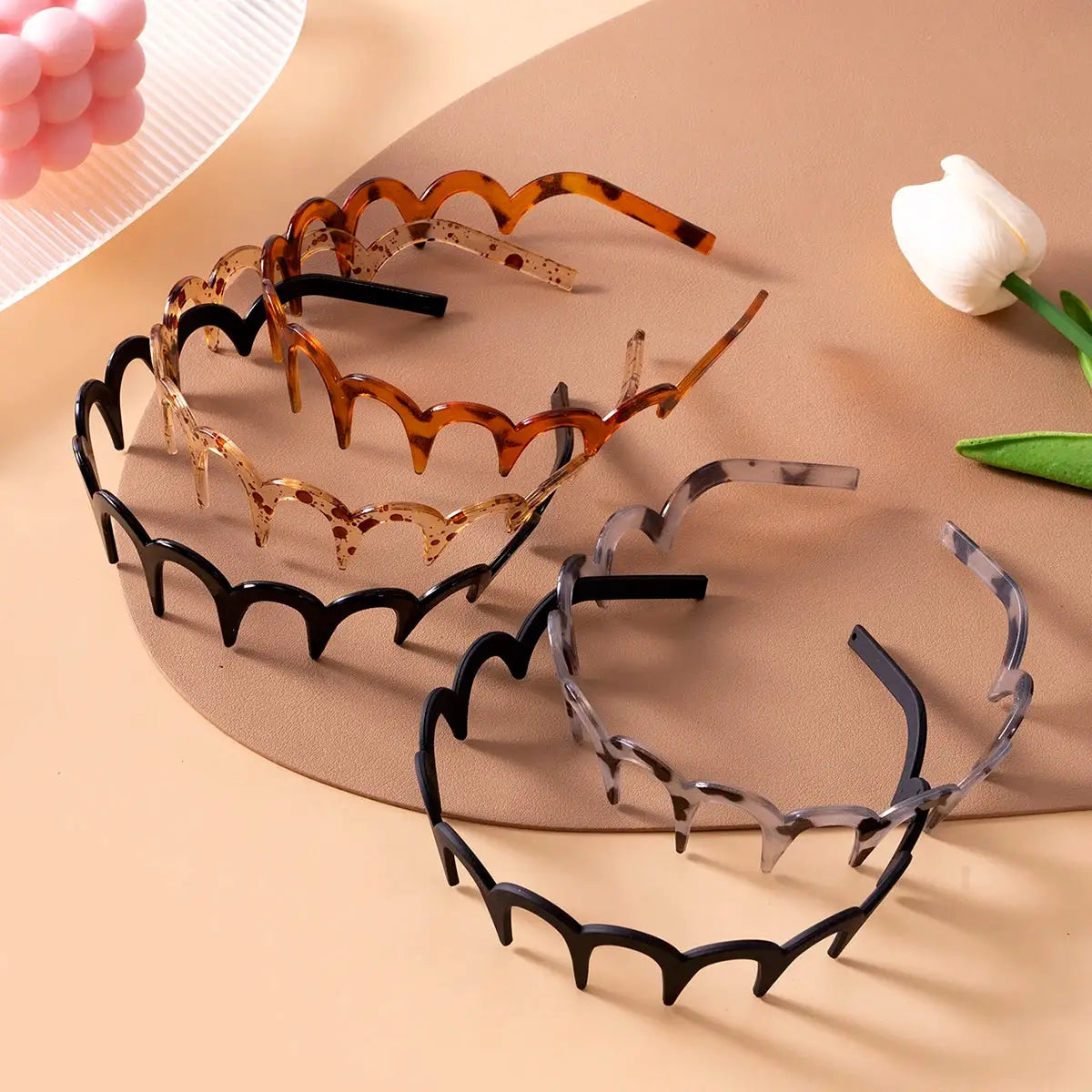 Korean women non-slip plastic U-shaped headbands set of five in black, amber, tortoiseshell, beige speckled, and clear.