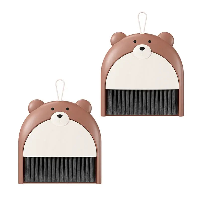Two bear-shaped mini broom and dustpan sets in brown with cream fronts and black bristles.
