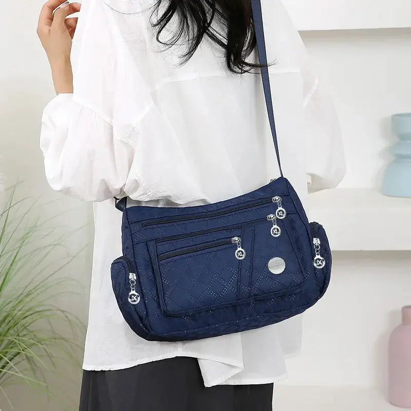 Simples Market navy nylon crossbody handbag with multiple compartments and zip pockets