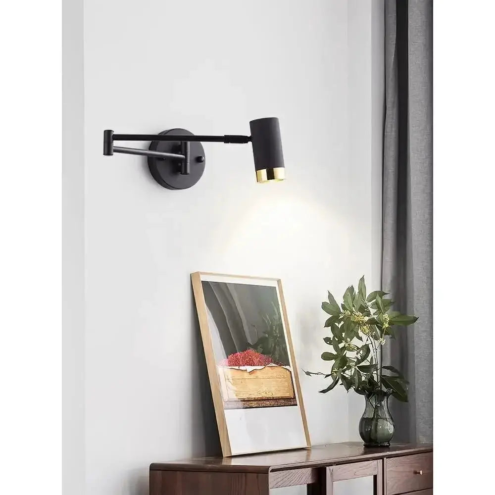 Simples Market black rocking-arm wall lamp with telescopic foldable arm and gold accent, ideal for reading.