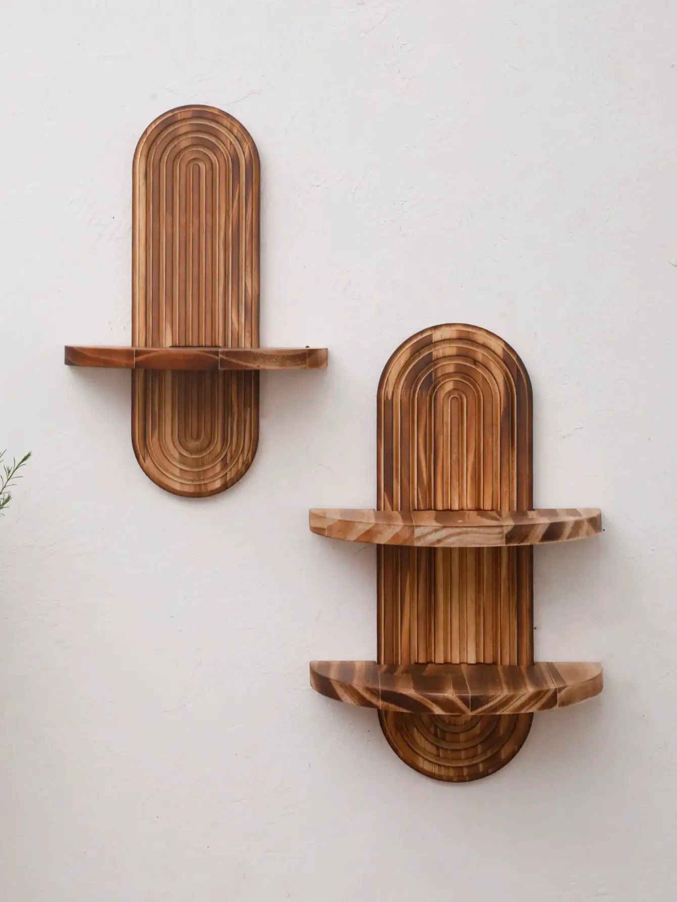Two boho style wooden wall shelves with arched layered panels in natural finish.