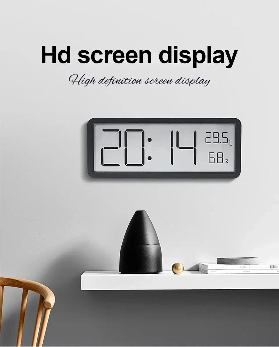 Simples Market LCD wall clock with black frame and large digital display showing time, temperature and humidity.