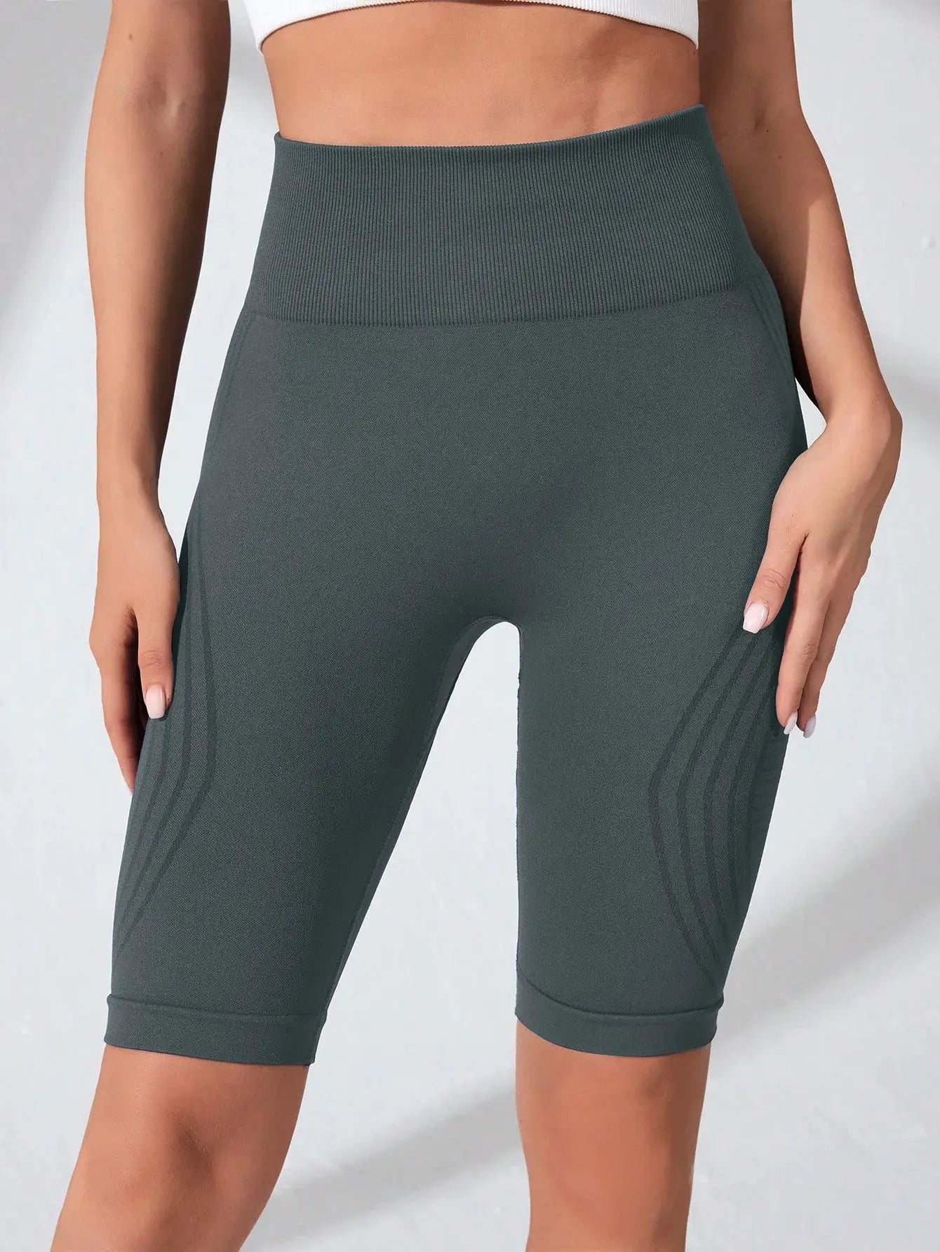 Simples Market high-waisted seamless yoga shorts, dark teal knitted fabric with ribbed waistband.