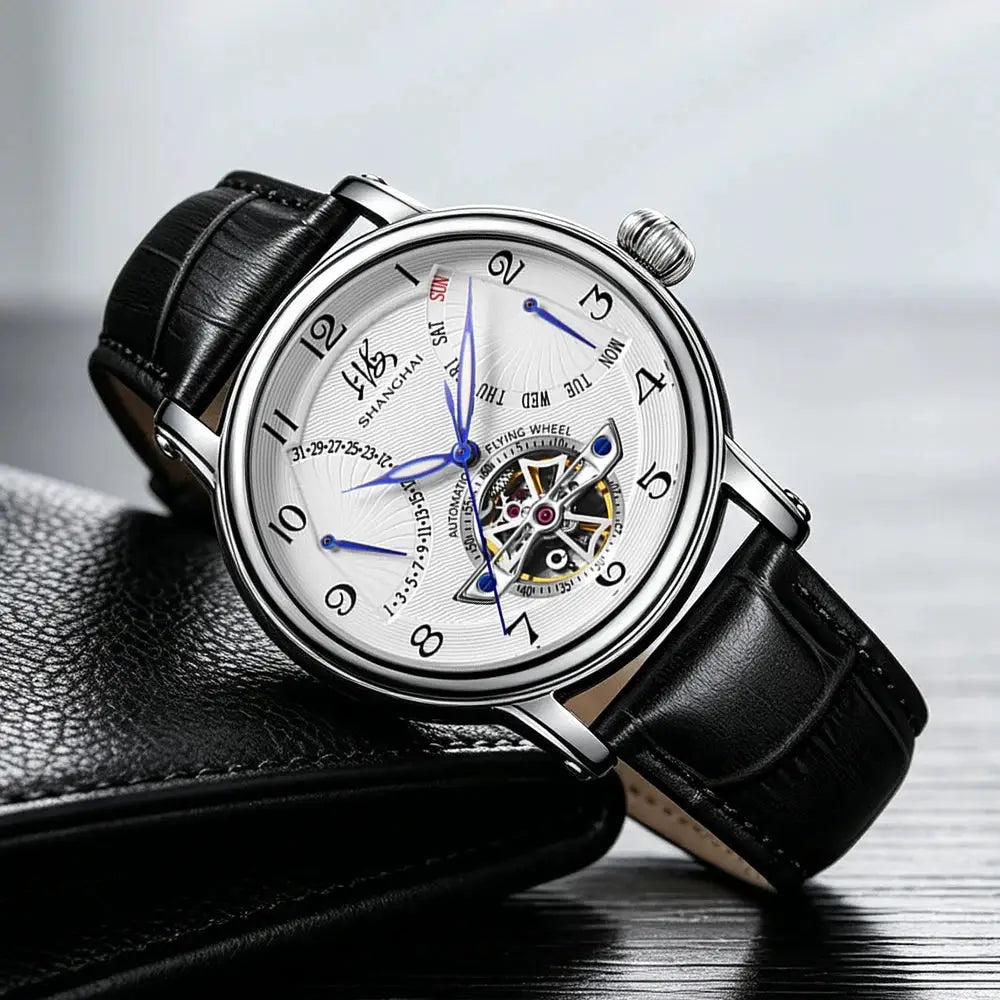 Shanghai Watch 42mm mechanical wristwatch with silver dial, blue hands, black leather strap and visible movement.