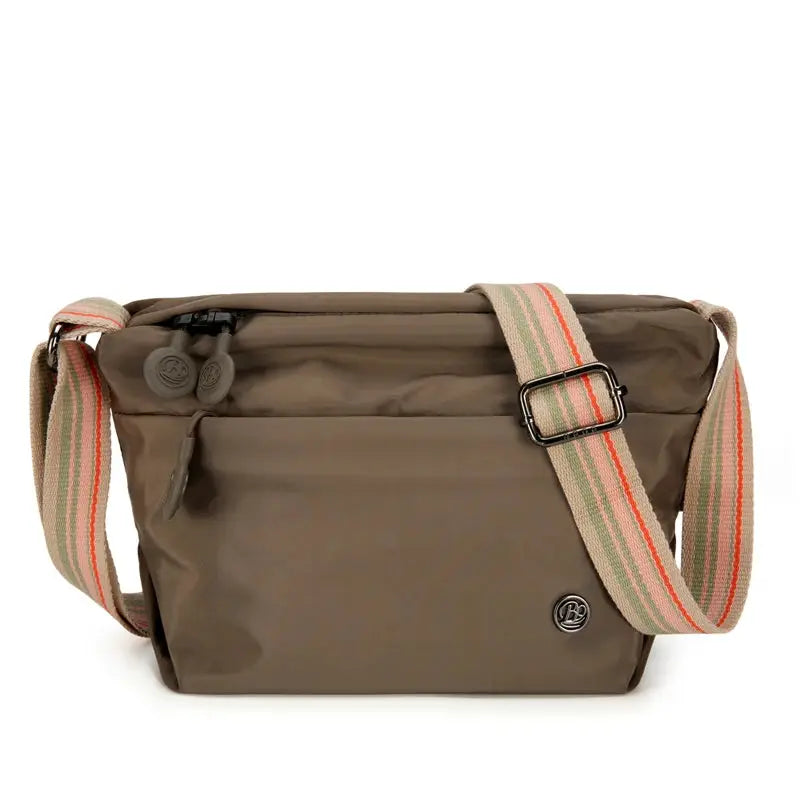 Simples Market ultra-light nylon crossbody bag in brown with adjustable wide striped strap and zipper closure.