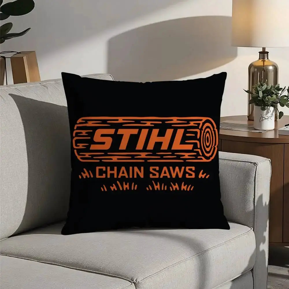 Pillow cover with STIHL logo in orange on black, double-sided plush cushion on sofa