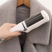 White handheld electrostatic pet hair remover brush with a black roller for clothing cleanup