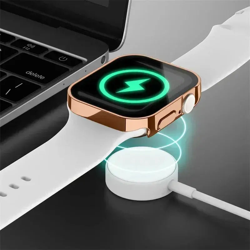 Apple Watch tempered glass screen protector with rose-gold PC bumper on white strap, charging on a dock