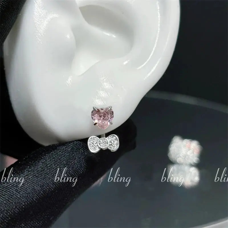Heart-shaped pink zircon ear stud with silver bowknot detail, 316L stainless steel cartilage earring