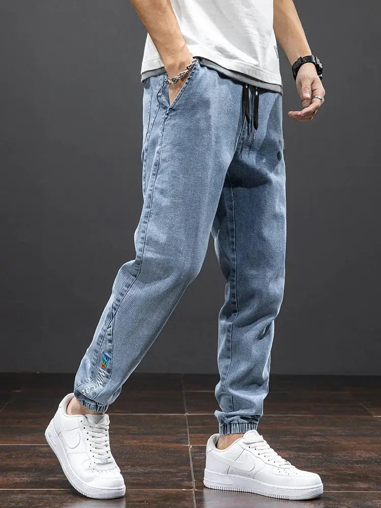 Men's denim cargo jogger pants by Simples Market in light blue with drawstring waist and elastic cuffs
