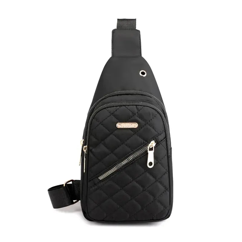 Shoulder bag by Simples Market, black quilted crossbody with gold zippers.
