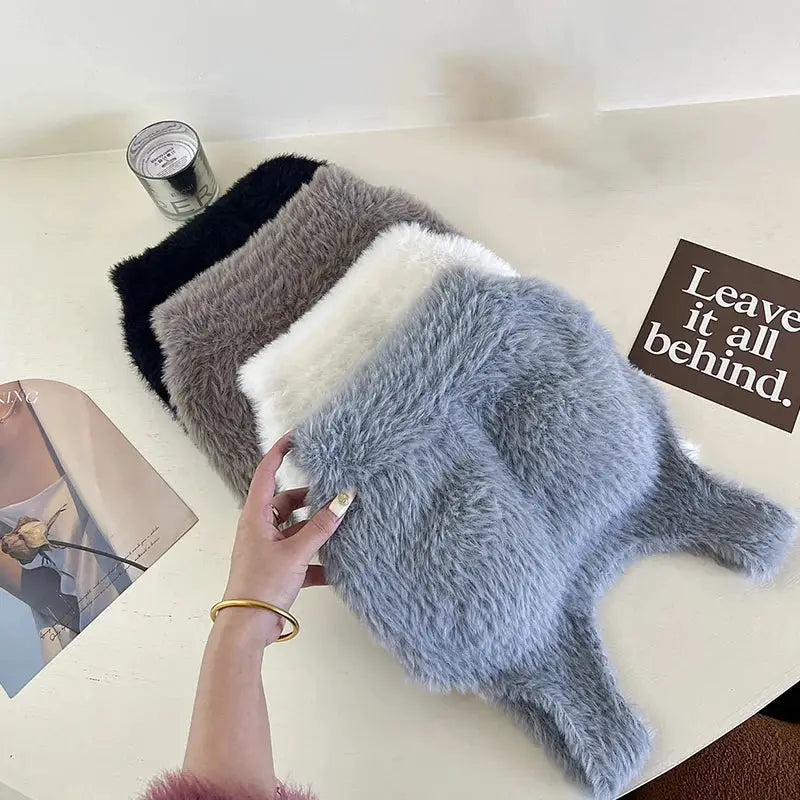Fluffy plush fur tops set in black, brown, white, and blue; one blue piece being held.