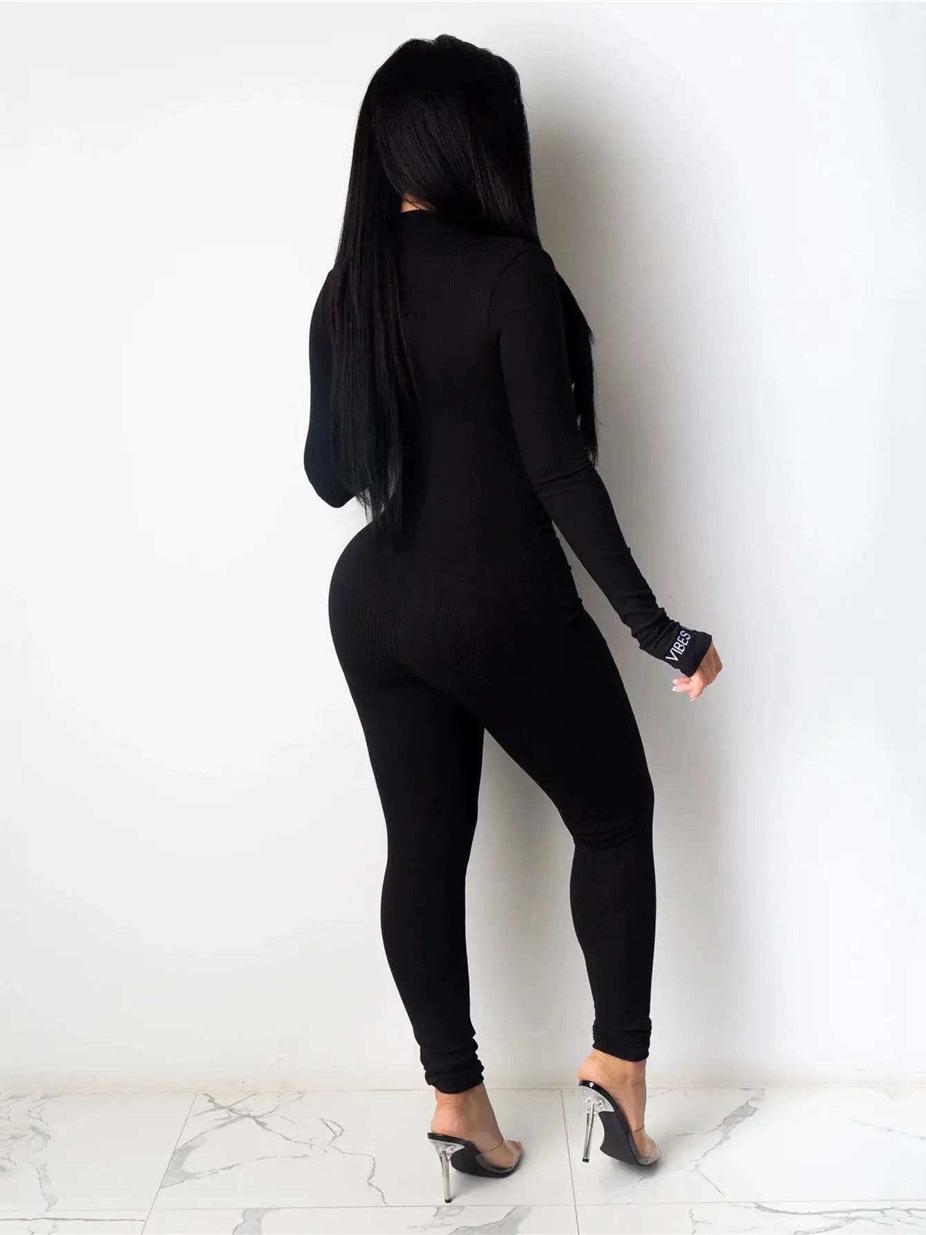 Women's black knitted bodycon jumpsuit with long sleeves; VIBES branded cuff