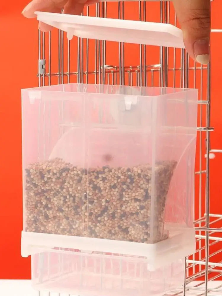 Parrot feeder: clear anti-spill plastic food box mounted on a metal bird cage.