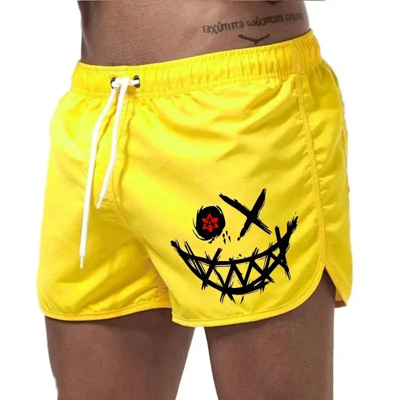 Men's yellow board shorts with bold black smile graphic and white drawcord