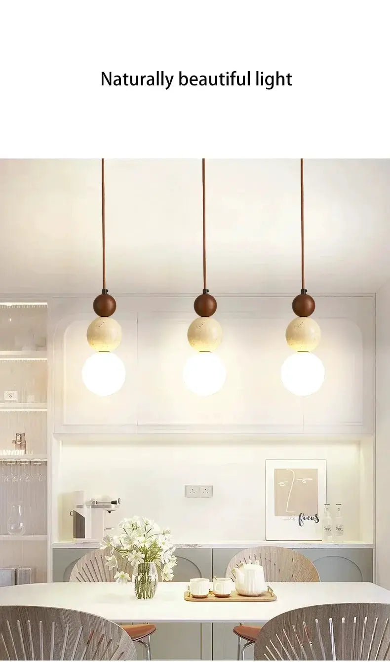 Cream style pendant lamp trio with stone and wood beads and warm glass globes