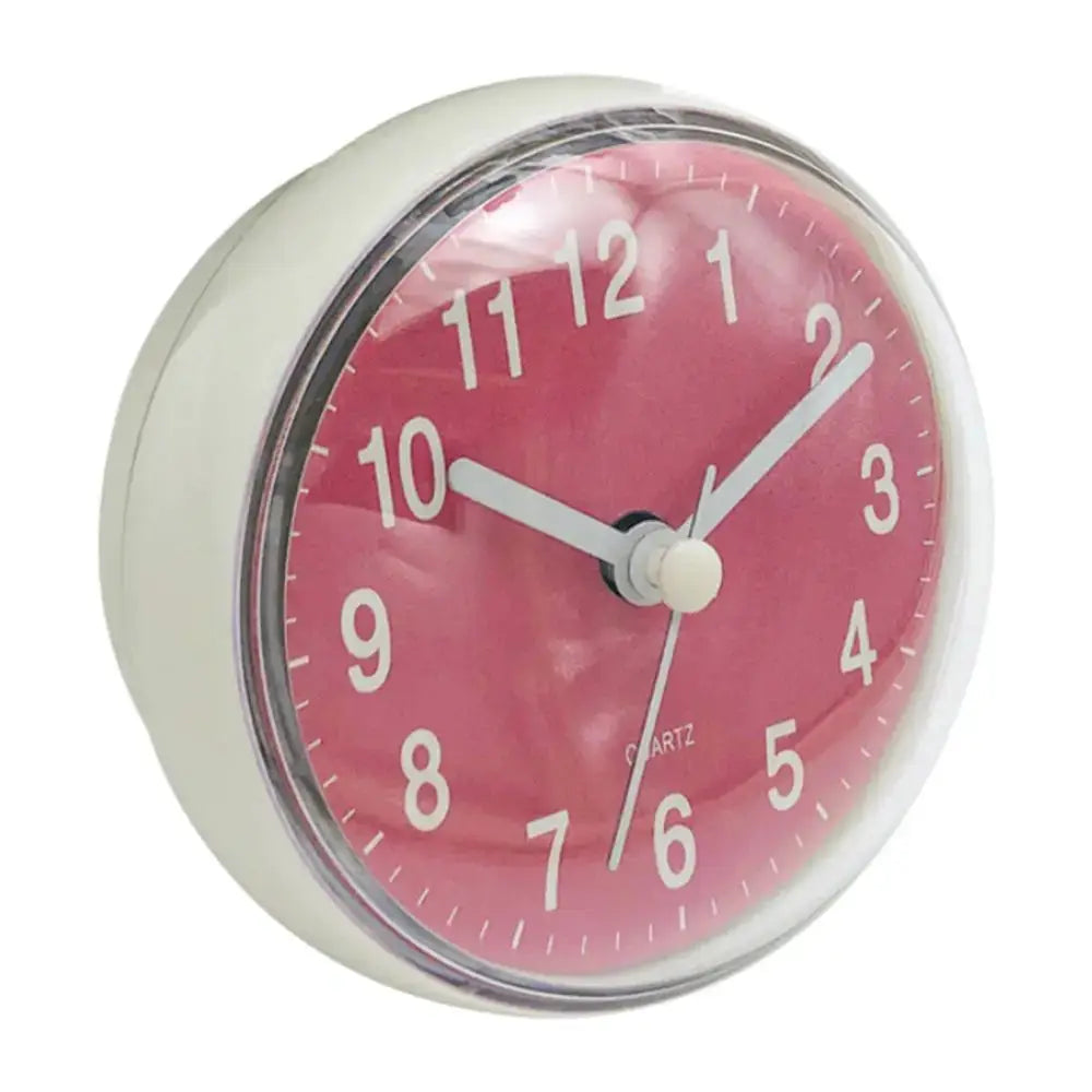 Mini pink-faced quartz clock with white frame, 7cm diameter.