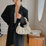 Dumpling handbag by Simples Market in cream PU, cloud-pleated handle