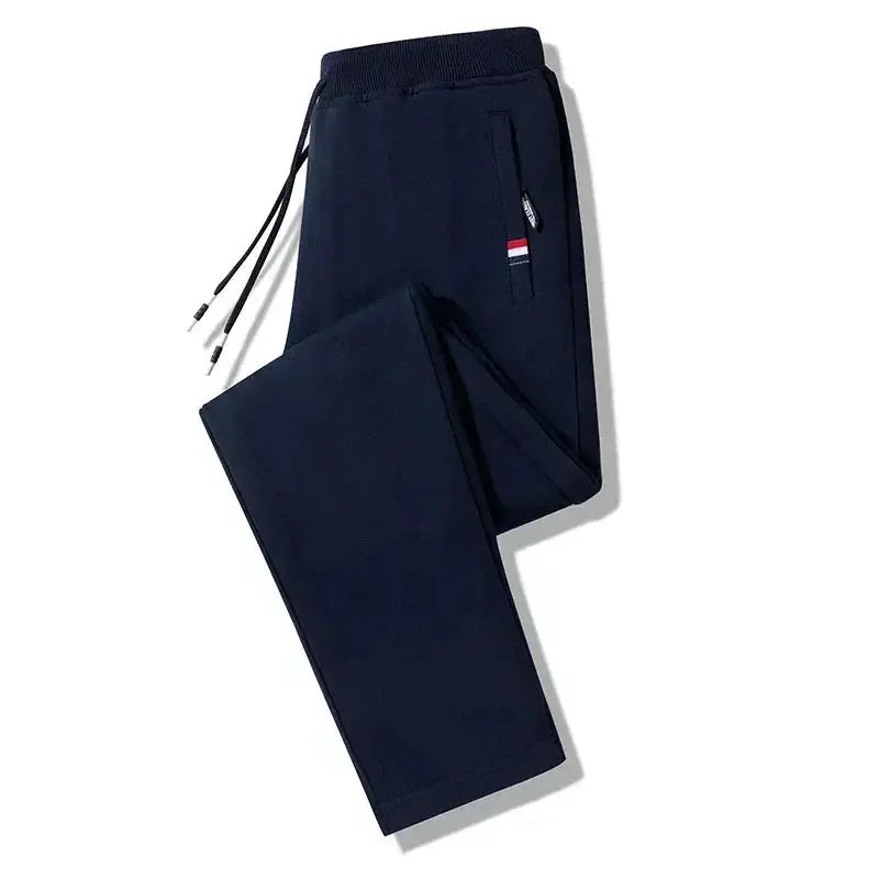 Men's navy cotton jogger pants with elastic waistband, drawstring and zip pocket.