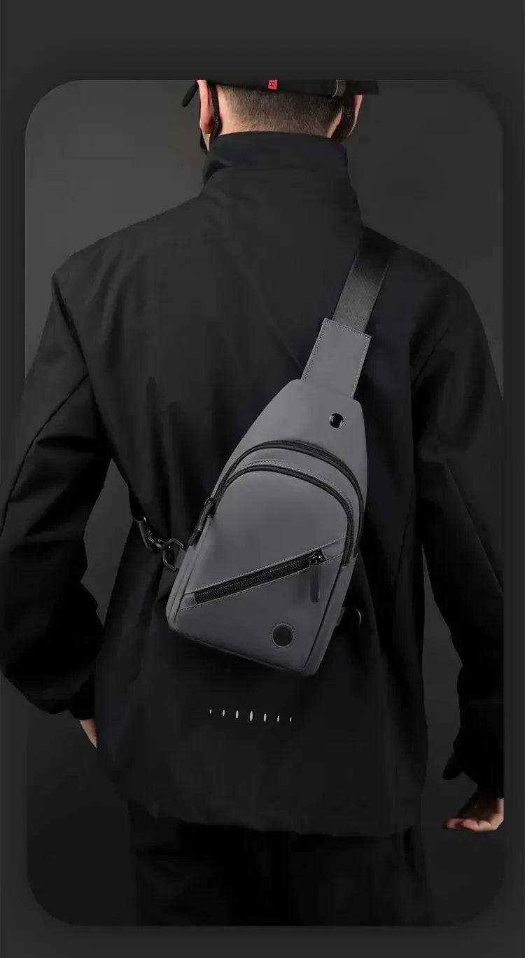 Lightweight men's chest bag in gray nylon with two zip pockets worn as a crossbody sling.